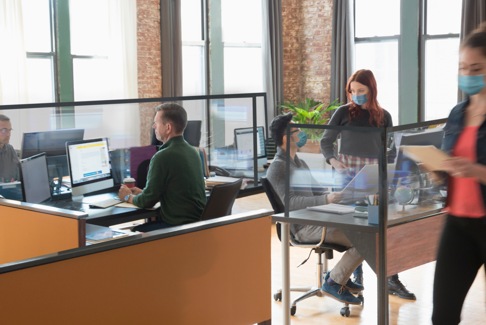 People in an office setting - some wearing masks