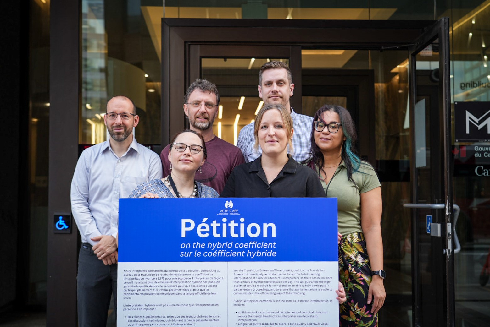 CAPE interpreter members with CAPE President Nathan Prier delivering a petition to TB CEO