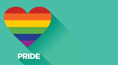 a heart in pride colours on a teal background with "pride" written below